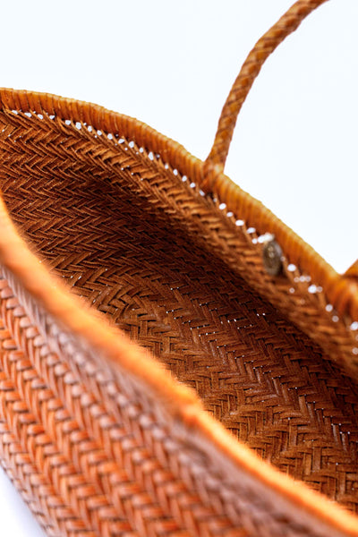 This is the bigger version of Dragon Diffusion’s iconic, best-selling bag — a roomy, hand-woven basket in smooth, buffalo calf leather. Handcrafted by artisan weavers in one piece, the diagonal chevron weave is what makes this style unique. And, remaining true to traditional basket weaving techniques, the bag comes unlined with an open top. Ideal for your next beach outing or a trip to your local market.