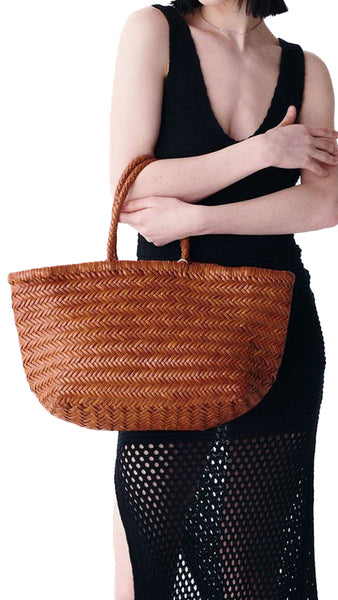 This is the bigger version of Dragon Diffusion’s iconic, best-selling bag — a roomy, hand-woven basket in smooth, buffalo calf leather. Handcrafted by artisan weavers in one piece, the diagonal chevron weave is what makes this style unique. And, remaining true to traditional basket weaving techniques, the bag comes unlined with an open top. Ideal for your next beach outing or a trip to your local market.