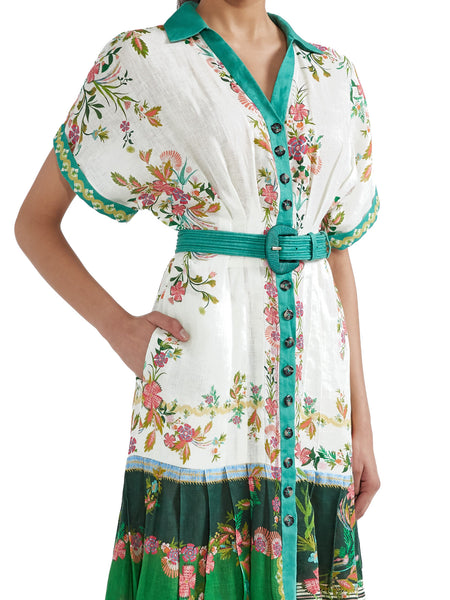 The Saloni Riya B is an elegant shirt dress with a cinched waist and a softly pleated full skirt. Delicate and eye-catching blossoms on a white and green colour-blocked background evoke the charm of Italian gardens and rose-strewn pergolas. Designed and cut to be cool and comfortable in the hottest weather, this linen dress, with its elevated detailing, is perfect for all events.