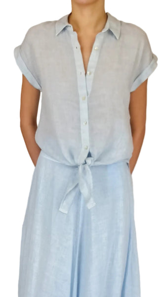 Person wearing a light blue striped shirt and skirt against a plain background