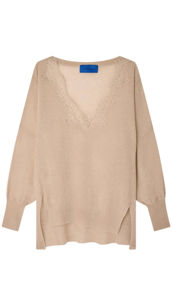 Beige sweater with a blue tag on a white background