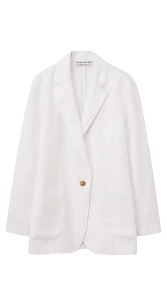 White blazer with a gold button on a light beige background