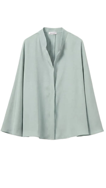 Light green blouse on a light gray background