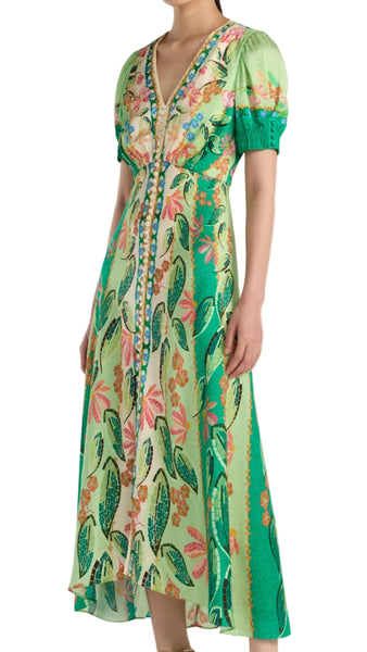 Woman wearing a green floral dress on a white background