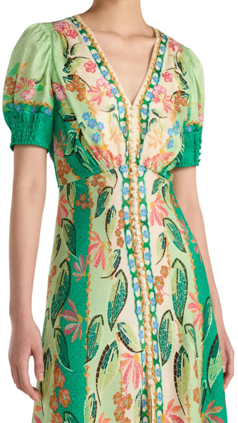 Colorful floral dress with green accents on a white background