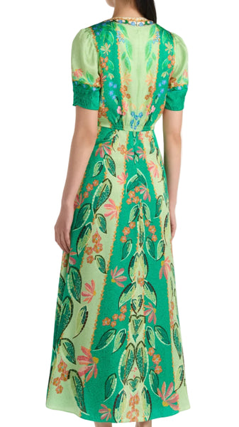 Woman wearing a green floral dress on a white background
