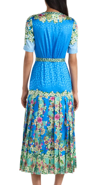 Woman wearing a blue floral dress on a white background