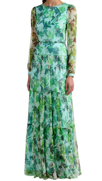 Woman wearing a long, floral-patterned dress on a white background
