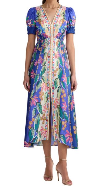 Woman wearing a colorful floral dress on a white background