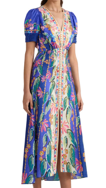 Woman wearing a colorful floral dress on a white background