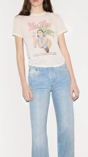 Woman wearing a graphic t-shirt and light blue jeans on a white background
