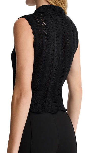 Woman wearing a black sleeveless top with a textured design on a white background