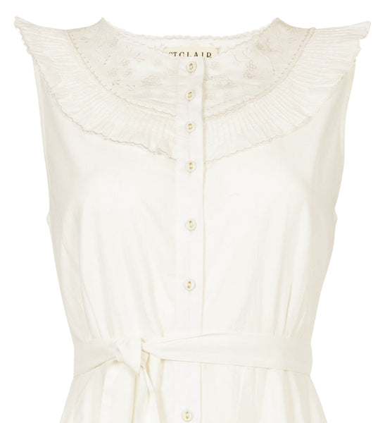 White sleeveless dress with buttons on a white background