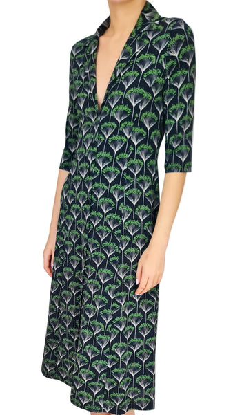 Woman wearing a patterned dress with a plain background