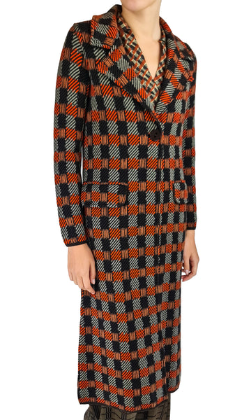 stand out in the Siyu Pavana Merino Wool Checkered Long Coat Cardigan. Featuring a burnt orange and sage green geometric grid, notched lapel, and single-button closure for winter layering.
 Siyu Pavana coat cardigan, checkered merino wool duster, luxury orange and sage cardigan, designer long wool coatigan, winter knit duster coat.