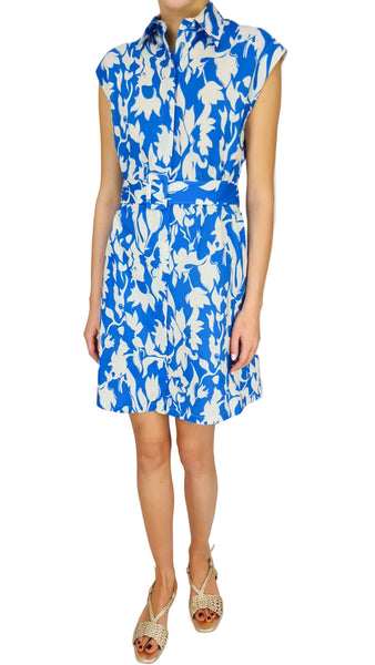 Woman wearing a blue and white floral dress on a plain background