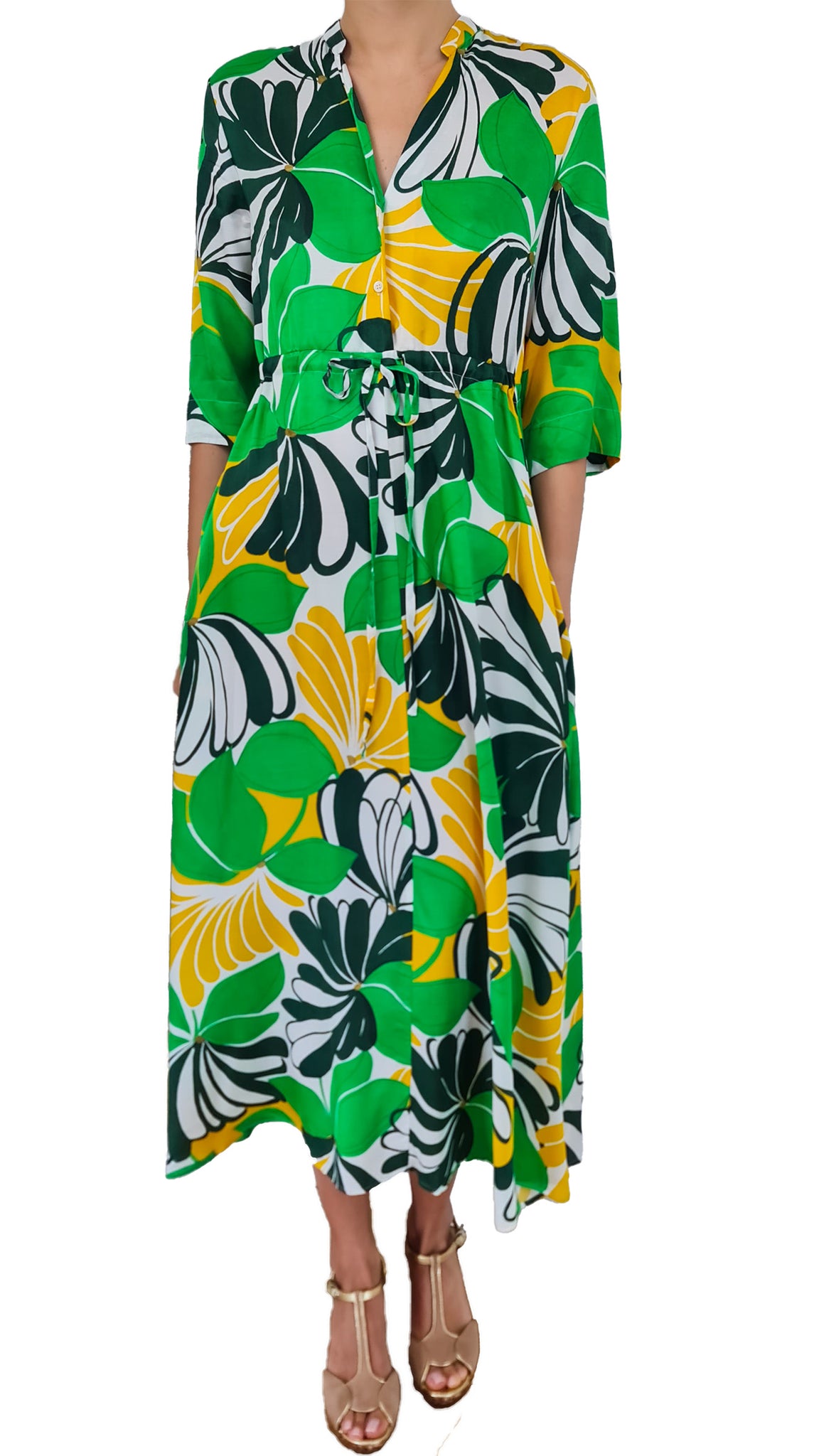 This dress features a bold and vibrant flower print in shades of green, white, and yellow. Stand out from the crowd and make a statement with this unique and eye-catching piece. Perfect for any summer occasion, this dress will bring a touch of tropical magic to your style.