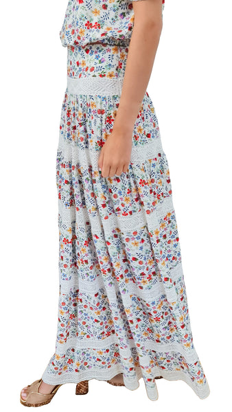 This stunning tiered floral skirt by Cecilia Prado showcases intricate embroidered details, adding a touch of elegance and femininity. Complete the look by pairing it with the matching Dina top for a super summery outfit. Perfect for any occasion, this skirt is a must-have for any summer style.