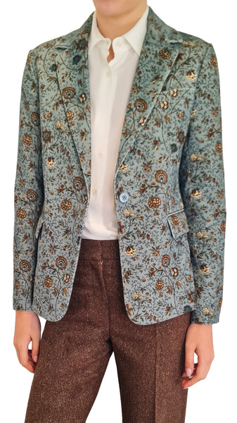 A woman wearing a light blue-green patterned blazer over a white collared shirt and brown trousers
 Circolo 1901 teal micro cord blazer
* Circolo autumn print floral corduroy blazer
* Women's teal patterned corduroy jacket
* Circolo 1901 autumn floral micro corduroy jacket
* Italian printed corduroy blazer women
* Teal blue autumn floral corduroy blazer Designer single breasted micro cord blazer Circolo 1901 teal printed tailored jacket