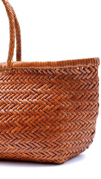 This is the bigger version of Dragon Diffusion’s iconic, best-selling bag — a roomy, hand-woven basket in smooth, buffalo calf leather. Handcrafted by artisan weavers in one piece, the diagonal chevron weave is what makes this style unique. And, remaining true to traditional basket weaving techniques, the bag comes unlined with an open top. Ideal for your next beach outing or a trip to your local market.