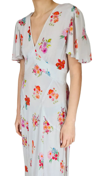 Woman wearing a floral dress with a plain background