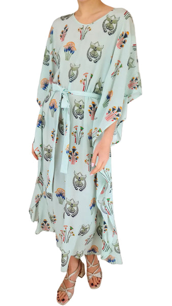 Person wearing a light blue dress with animal print on a white background