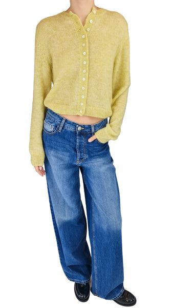 A model wearing a cropped, long-sleeve yellow knit cardigan with white buttons and wide-leg blue jeans
* Masscob Bailen citric yellow cropped cardigan
* Masscob citric yellow cardigan Women's cropped yellow cardigan knit
* Masscob Bailen yellow sweater
* Soft citric yellow button front cardigan
* Designer cropped yellow knitwear
* Women's lime yellow cardigan sweater Masscob cropped round neck cardigan