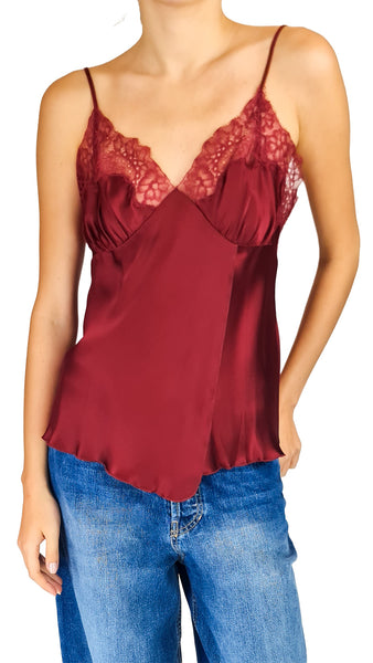 A woman wearing a burgundy satin camisole top with red lace cups and thin spaghetti straps

burgundy red silk lace camisole • women's lace trim cami top • wine red v-neck silk top • spaghetti strap lace camisole • luxury silk evening tank top