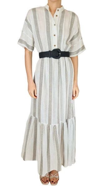 Person wearing a striped dress with a belt on a plain background