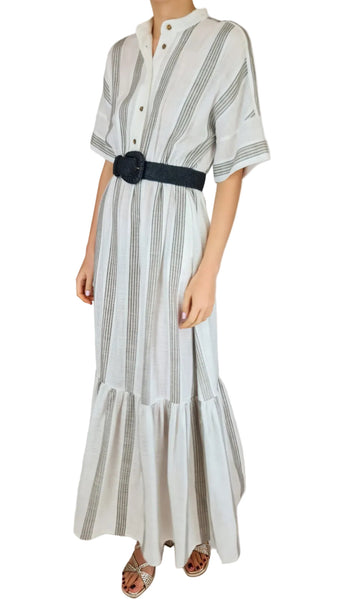 Woman wearing a striped dress with a black belt on a plain background