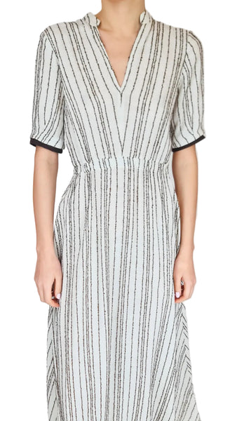 Woman wearing a striped dress with a plain background