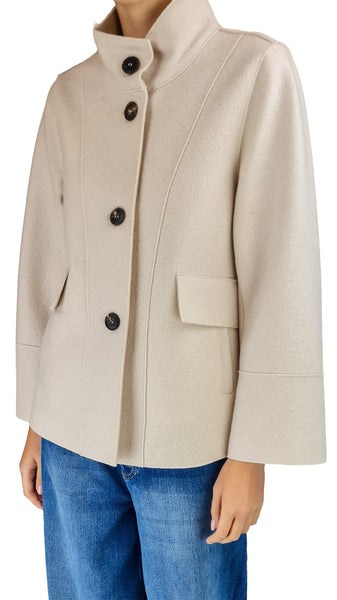A person wearing a light beige cropped jacket with a high stand collar, dark buttons, and flap pockets, paired with blue jeans

Luxury women's wool jackets

Italian designer wool jacket

Women's short wool coat cream

Smart casual cream outerwear

Structured wool jacket for women