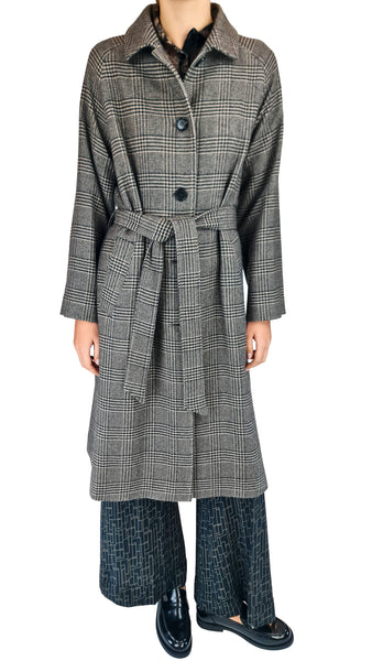 A model wearing a long gray and black plaid coat with a matching waist tie, paired with wide-leg dark trousers and black leather loafers, set against a plain white background.