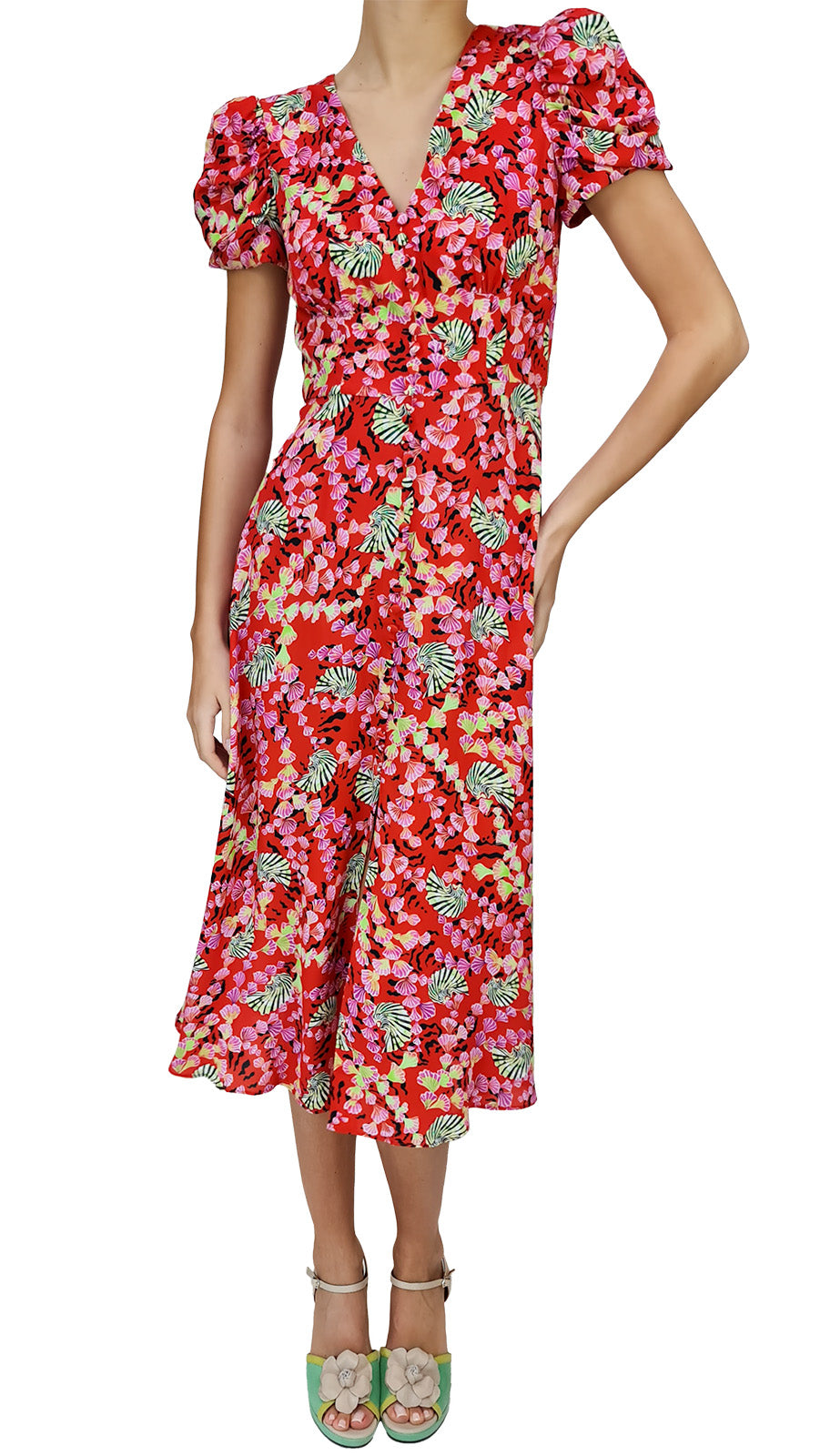Every wardrobe needs a go-to flowery dress, and this Saloni dress is the ultimate choice for all manner of sartorial occasions. A vivid print of cascading shells and sun-kissed fiery rouge ripples. Classic in feel but contemporary in silhouette, this midi-length dress features an elegant V-neckline at the front and back, with puffed sleeves that add a sculptural feel, and soft gathers around the bust. 