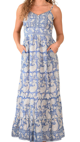 Woman wearing a blue and white patterned dress on a white background