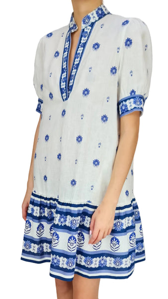 White dress with blue floral patterns on a plain background