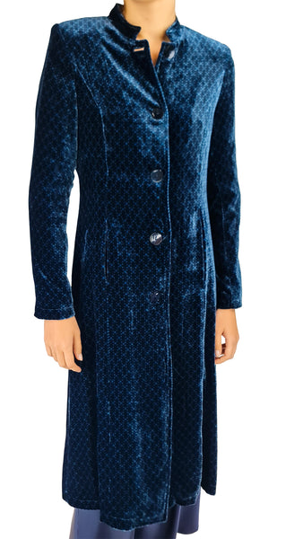 A long-sleeved, knee-length navy blue velvet coat with a subtle geometric pattern, featuring a mandarin collar and front buttons, shown on a model against a white background.