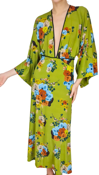 Green floral dress worn by a model on a plain background