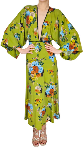 Green floral dress worn by a person on a white background