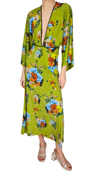 Woman wearing a green floral dress on a white background