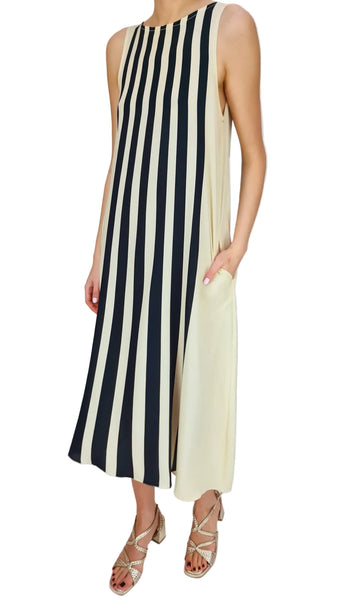 Woman wearing a black and white striped dress on a plain background
