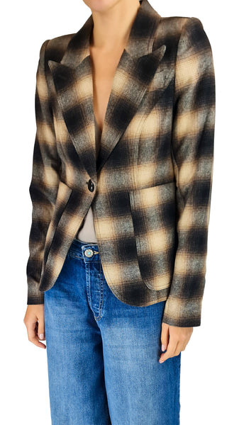 A woman wearing a cropped, single-breasted blazer with a brown, beige, and black plaid pattern, paired with blue jeans, shown against a plain white background.