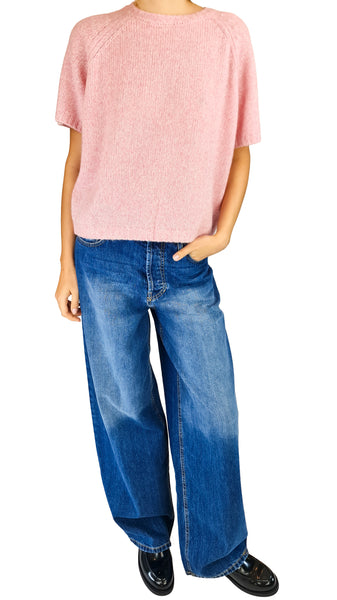A model wearing a light pink short-sleeve knit top and wide-leg blue jeans

pink short sleeve cashmere sweater • women's melange pink knit top • raglan short sleeve cashmere jumper • heathered pink crewneck sweater • luxurious short sleeve knitwear
