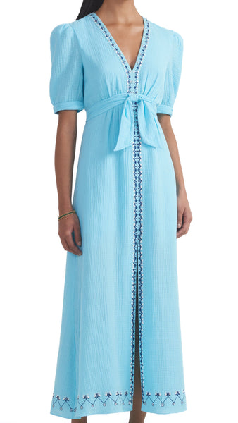 This stunning cotton dress features a fitted waist for a flattering silhouette and a v-neckline for added elegance. The textured cotton fabric adds a touch of fun while the beautiful cloud blue colour will make you stand out in any crowd.  100% cotton. Dry clean.