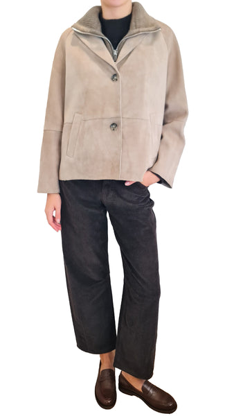A person wearing a light beige suede jacket with a high collar and front zipper
Discover The Jackie Leathers Sole Beige Suede Jacket. Italian beige suede coat featuring a two-button closure and a detachable ribbed zip-up collar. Shop now!
* The Jackie Leathers Sole beige suede jacket
* The Jackie Leathers suede jacket detachable collar
* Women's beige suede jacket with zip insert
* Luxury Italian beige suede jacket women
* Suede jacket with removable collar layer
* Short beige suede button jacket
* Designer