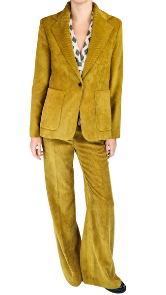 A model wearing a matching mustard yellow corduroy blazer and wide-leg trousers set, styled with a patterned shirt and black shoes, against a plain white background.
mustard yellow wide-leg corduroy pants • high-waisted corduroy trousers • women's flared corduroy pants • 70s style corduroy co-ord pants