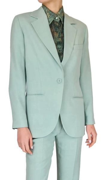 Mint green suit with a patterned shirt on a plain background